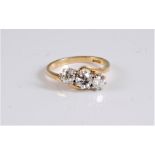 An 18ct three stone crossover diamond ring, the three old cut diamonds, estimated approx. 1.22cts,