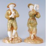 A pair of Royal Worcester shot enamel figures, the Boy-piper Strephon with female companion,