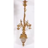 An early 20th century gilt metal electrolier, the centre column issuing four lights over a glazed