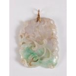 A Chinese carved jade pendant, the off-rectangular pendant carved with a crane and lotus flowers and