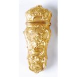 A George III gilt metal etui, worked in high relief with a figure to either side within C-scrolls,