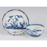 A Worcester porcelain tea bowl and saucer, underglaze blue painted in the Candle Fence pattern,