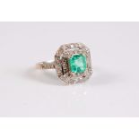 An 18ct Art Deco style emerald and diamond ring, the central square emerald cut emerald,