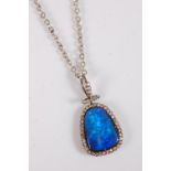 A black opal and diamond pendant, the rounded pear shape black opal, approx. 21 x 15.3 x 5.2mm,