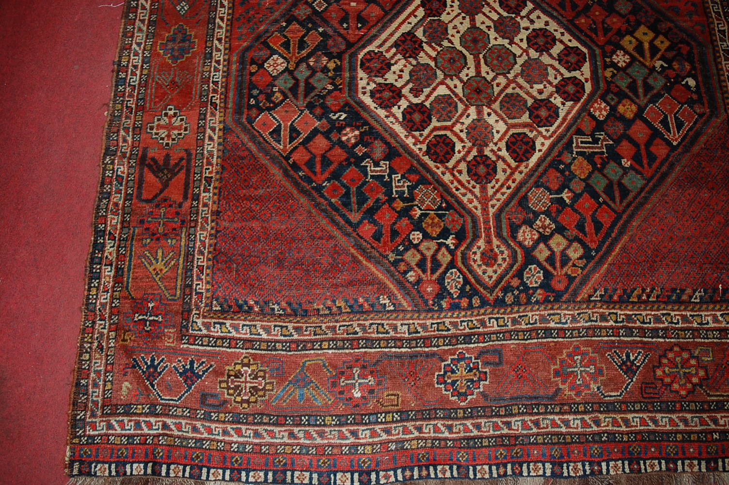 A late 19th century Persian woollen Luri rug, the rust coloured field decorated with three linked - Image 2 of 7