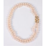 A two strand cultured pearl necklace with 18ct diamond clasp, the two strand uniform cultured