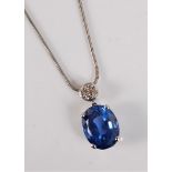 A sapphire and diamond pendant, the oval mixed cut sapphire, approx. 14 x 11 x 7.5mm, in a four claw