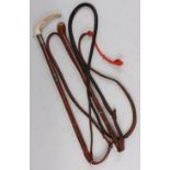 A 1930's plaited leather clad riding crop, having two silver collars and a stag antler handle, maker