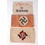 A German NSDAP party armband, together with two other German armbands. (3)