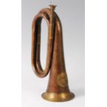 A brass and copper bugle with applied U.S. crest.