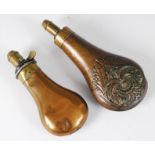 A 19th century copper powder flask of plain undecorated form, having a brass graduated charger 2 1/2