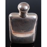 An Edwardian silver hip flask of plain undecorated form, having a bayonet cap and removeable cup