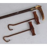An early 20th century riding crop, having a plaited leather shaft and stag antler handle, 66cm,