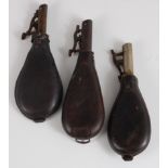 A 19th century leather shot flask of typical pear shape with suspension ring, 20cm, together with