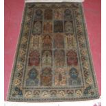 A Persian woven silk rug, having five rows of boxed reserves within multiple trailing tramline