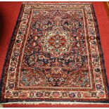 A Persian woollen Tafresh rug, having a floral decorated blue ground within trailing tramline