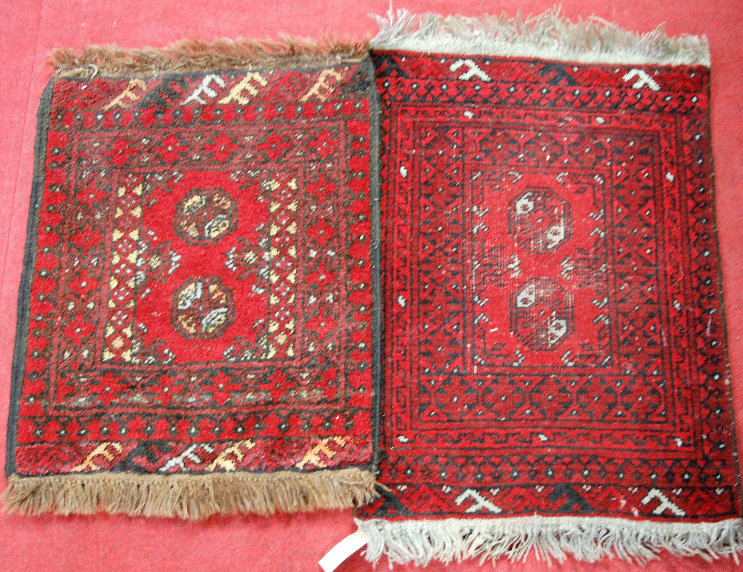 Two Persian red ground Bokhara prayer rugs