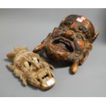 A large carved softwood and painted tribal wall mask, h.32cm; together with a reticulated example (