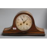 A 1930s oak cased mantel clock having a silvered dial with Arabic numerals and eight day movement,