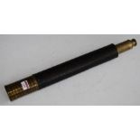 An early 20th century brass and leather clad single drawer telescope, max length 85cm