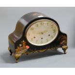 A 1920s chinoiserie decorated mantel clock, having an oval silvered dial with Arabic numerals and