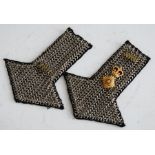 A pair of chainmail epaulettes, each with 10th Royal Hussars Regiment brass shoulder title