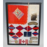 A collection of Canadian cap badges, cloth badges, and shoulder titles etc