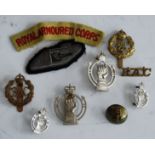 A collection of Royal Armoured Corps cap badges, cloth badges, and shoulder titles