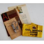 A Civil Defence Corps Welfare embroidered armband; together with a Hudson ARP whistle; an Air Raid
