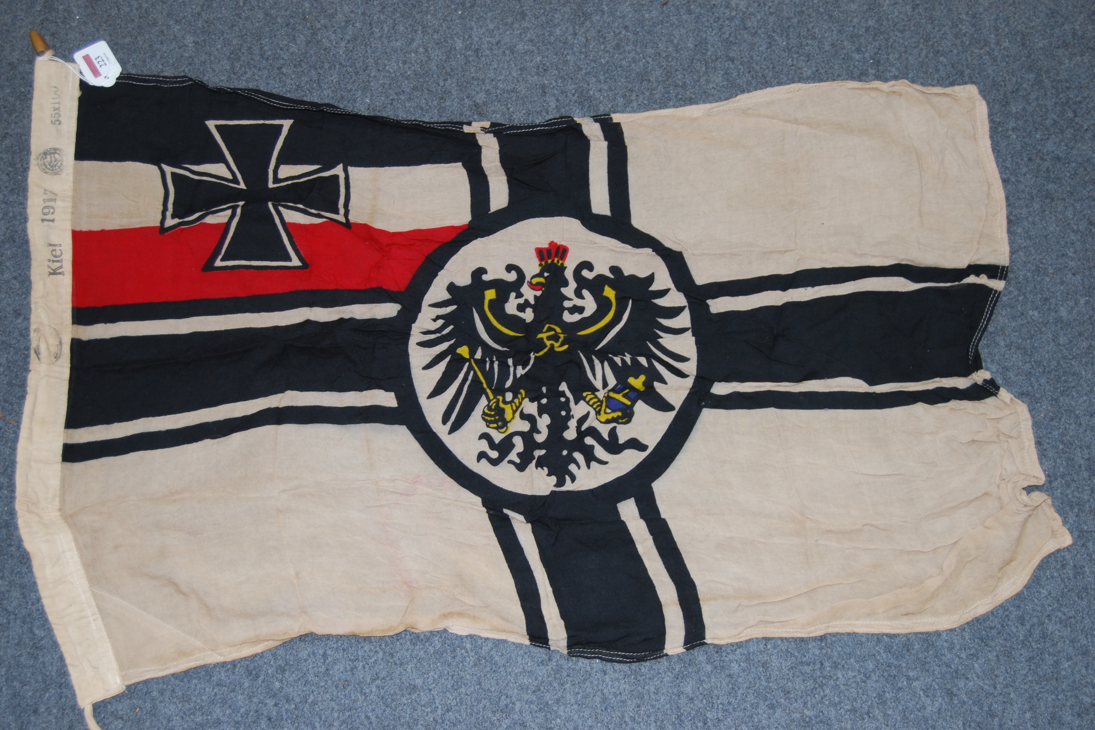 An Imperial German battle flag, stamped Kiel to the lanyard and dated 1917, 55 x 100cm