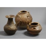 An earthenware burial type vase of squat circular form having four loop handles, height 18cm,