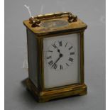 An early 20th century lacquered brass cased carriage clock having enamel dial with Roman numerals