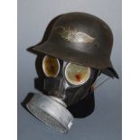 A German Luftschutz steel helmet, with logo; together with a German G70 respirator (2)