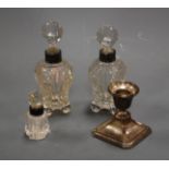 A George V silver dwarf table candlestick; together with three cut glass scent bottle sand stoppers,