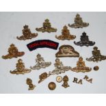 A collection of Royal Artillery cap badges, shoulder titles and buttons etc