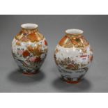 A pair of Japanese Meiji period kutani vases, of baluster form, typically decorated with pagodas