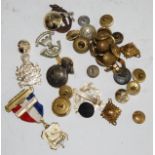 A collection of assorted cap badges, buttons and insignia, to include Royal Military Police