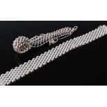 A modern silver chain link bracelet; and one other similar gatelink example (2)