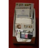 A box of assorted loose stamps and first day covers dating mainly from the 1980s