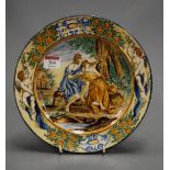 A 19th century Italian majolica glazed plate, the centre typically decorated with figures within a