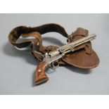 A reproduction model of a Colt revolver, having all-over engraved frame and cylinder, in leather