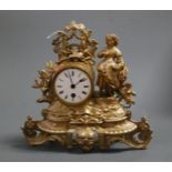 A late 19th century French gilt metal mantel clock having a circular dial with Roman numerals and