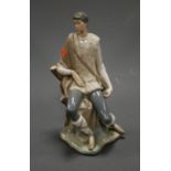 A large Lladro porcelain figure of a young man seated on a treestump, having printed mark verso, h.