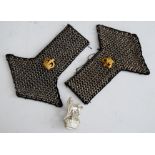 A pair of chainmail epaulettes; together with a cap badge (3)