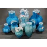 A collection of Victorian blue glass ware to include a pair of iridescent vases of lobed form,