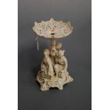 A Victorian parian table centrepiece, the pierced bowl on embossed column, supported by The Three