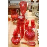 A collection of Victorian and later cranberry glassware to include etched biscuit barrel and