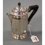 An Edwardian silver hot water pot with ebonised handle 11.2oz, marks worn, height 18cm