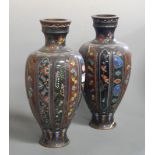 A pair of Japanese Meiji period cloisonne vases of fluted baluster form typically decorated with
