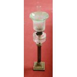 A Victorian oil lamp, having a frilled etched green tinted glass shade above a clear glass font,